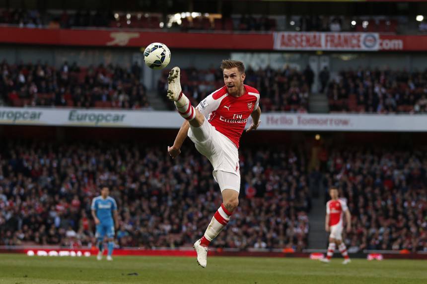 Arsenal's Welsh midfielder Aaron Ramsey jumps for the ball during the English Premier League football match between Arsenal and Sunderland at the Emirates Stadium in London on May 20, 2015. AFP PHOTO / ADRIAN DENNIS RESTRICTED TO EDITORIAL USE. NO USE WITH UNAUTHORIZED AUDIO, VIDEO, DATA, FIXTURE LISTS, CLUB/LEAGUE LOGOS OR LIVE SERVICES. ONLINE IN-MATCH USE LIMITED TO 45 IMAGES, NO VIDEO EMULATION. NO USE IN BETTING, GAMES OR SINGLE CLUB/LEAGUE/PLAYER PUBLICATIONS.        (Photo credit should read ADRIAN DENNIS/AFP/Getty Images)